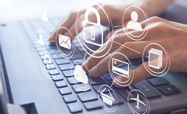 Hands typing on a laptop keyboard with floating icons representing security and data protection