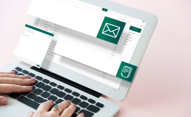 Tablet displaying an email marketing template interface with message and menu icons, hands typing on keyboard