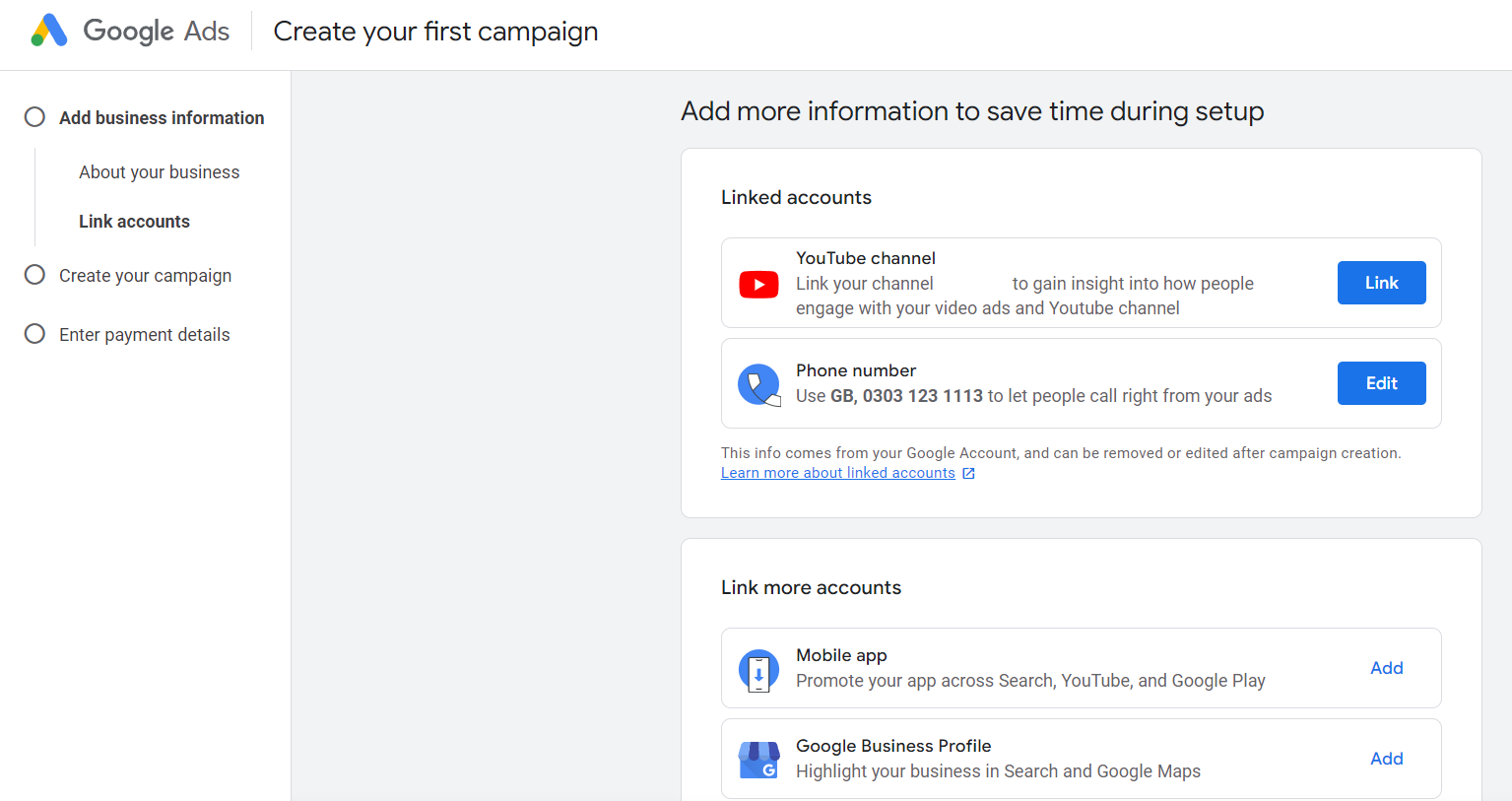 Google Ads interface for creating a campaign showing options to add business information with sections for linking YouTube channel and phone number, and options to link mobile app and Google Business Profile accounts
