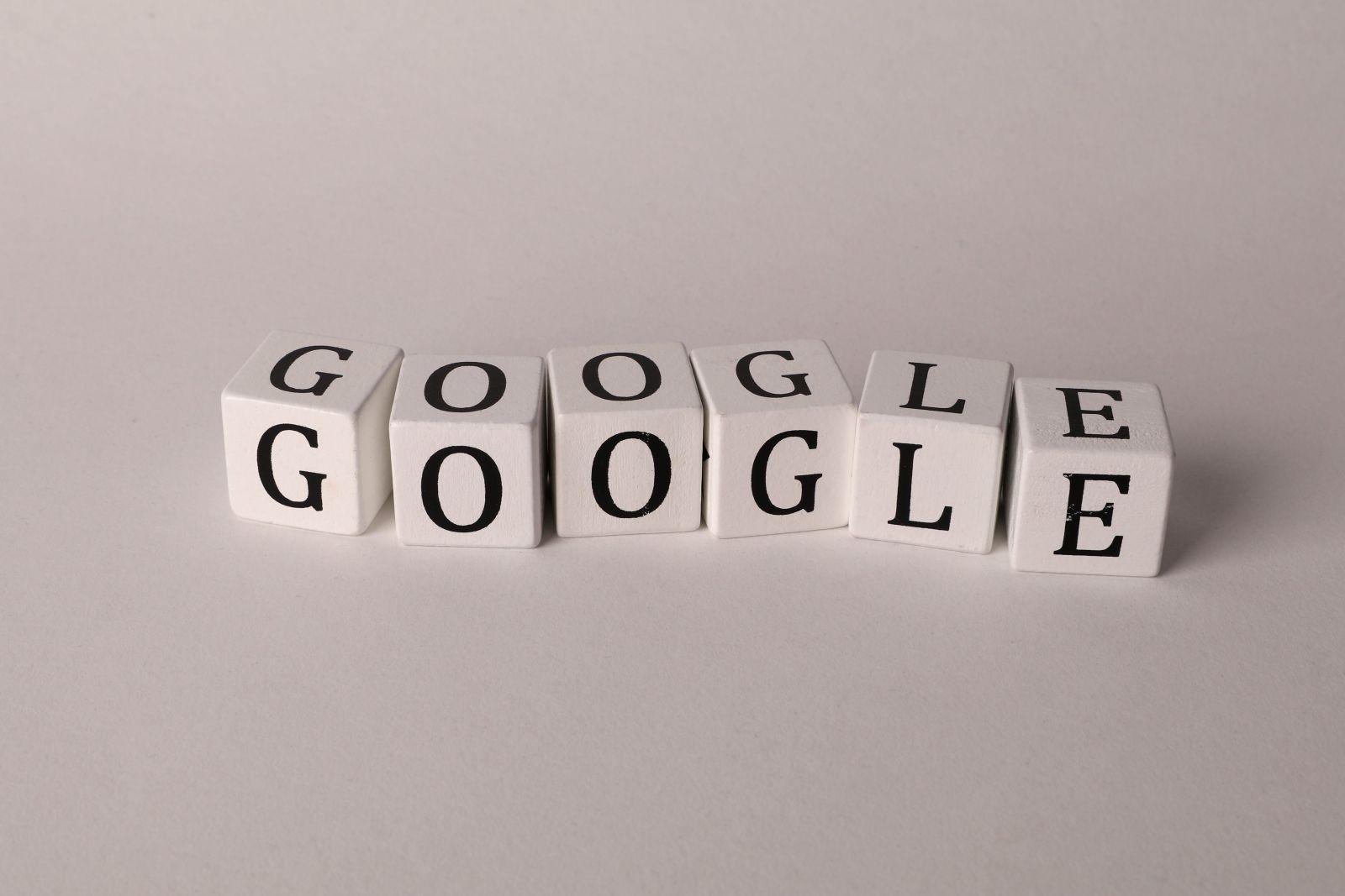 White blocks with black letters spelling 'Google' arranged in a row on a plain background