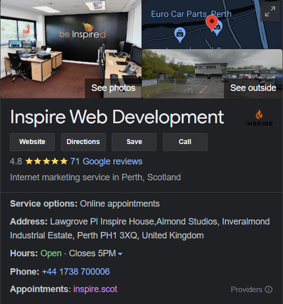 Office interior of Inspire Web Development with desks, computers and a wall displaying the company logo