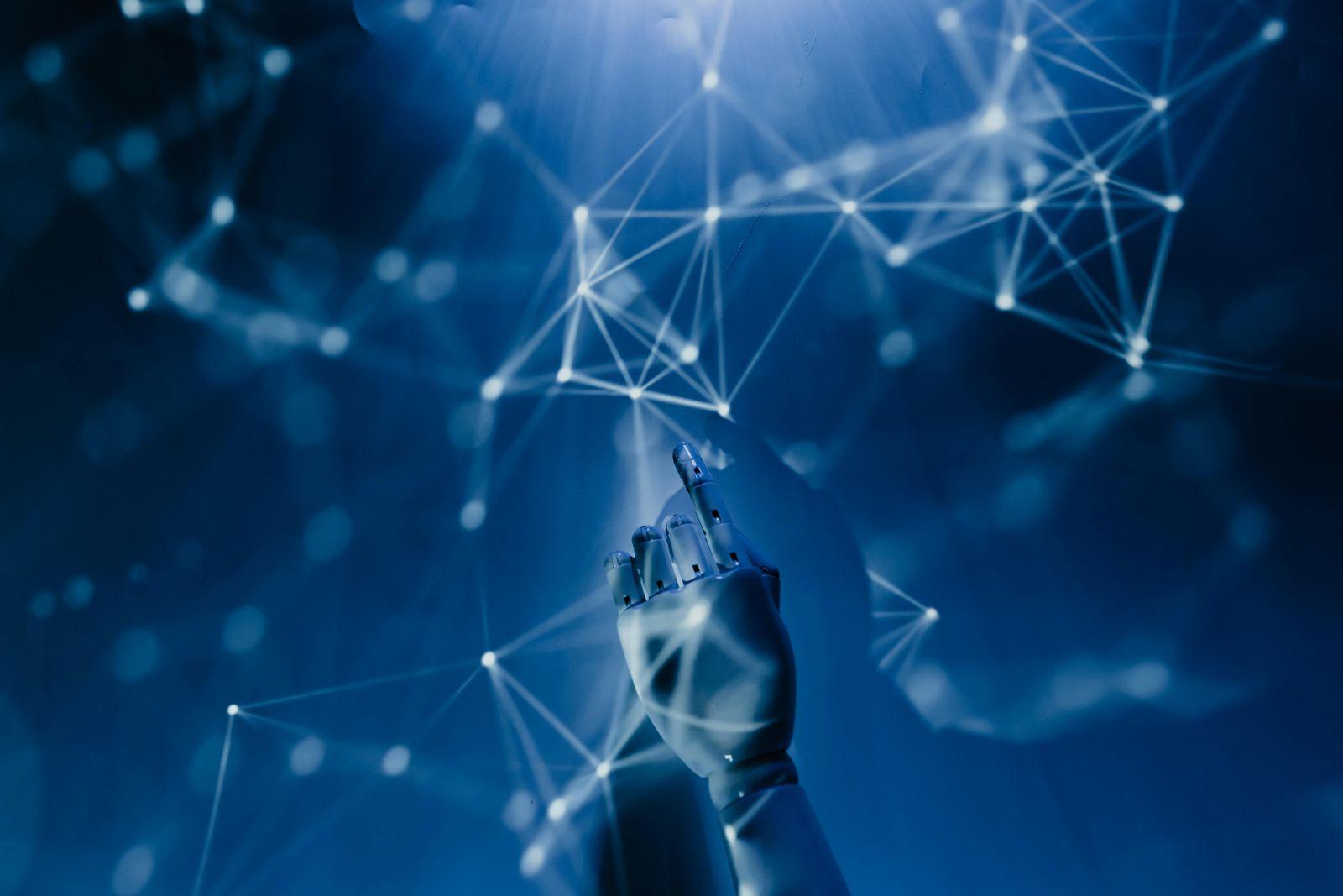 Robotic hand reaching towards and interacting with glowing digital network connections on a blue background