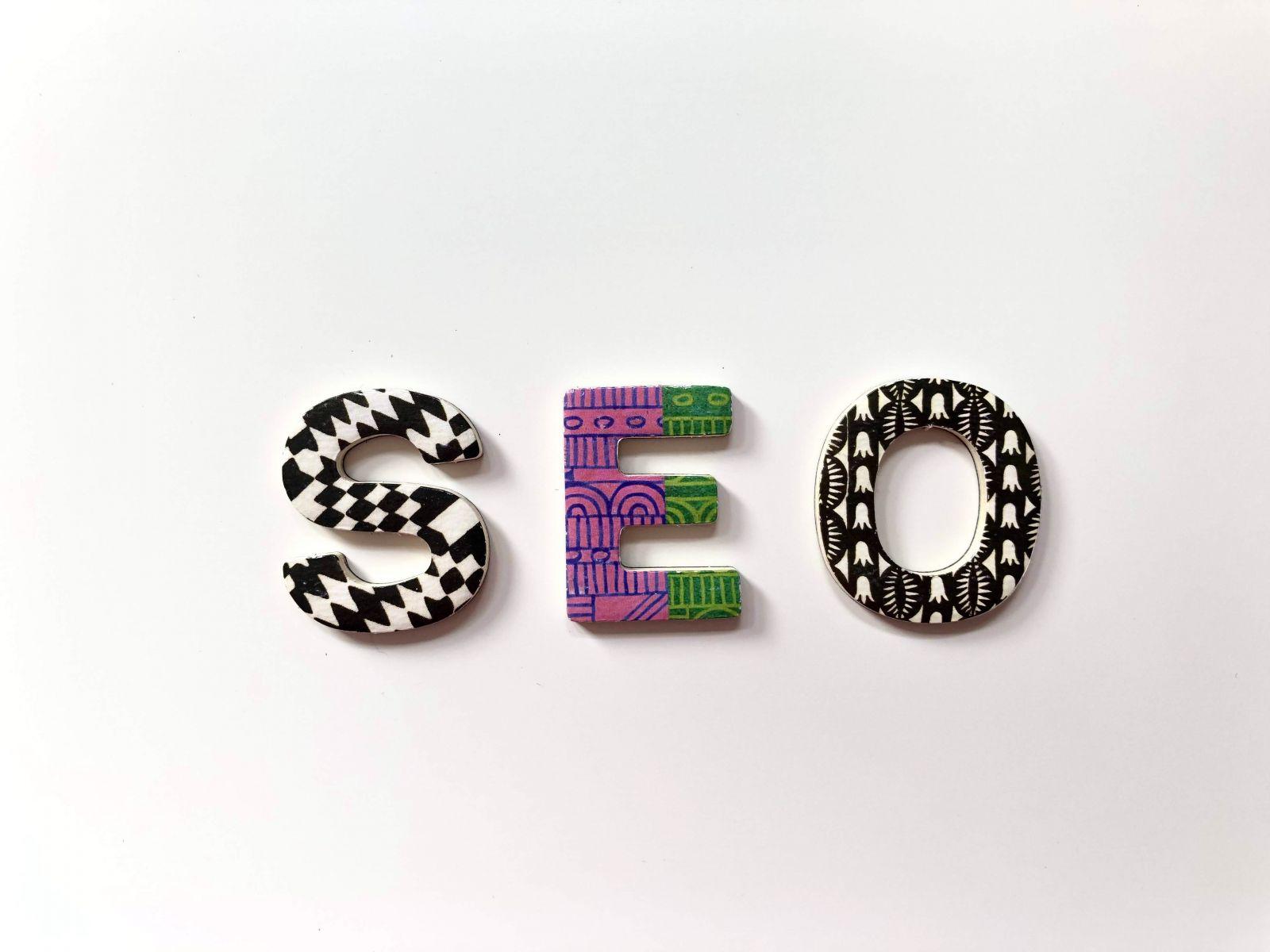 Three decorative letter blocks spelling SEO on a white background with varied black-and-white and coloured patterns