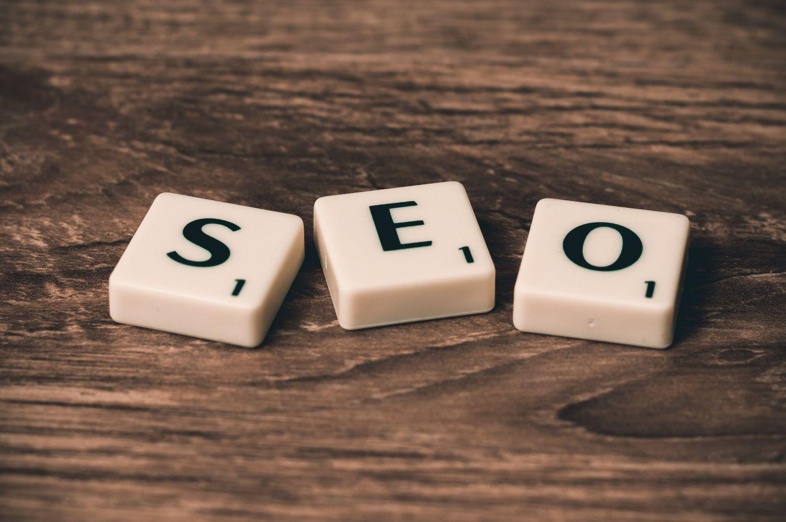 Scrabble-style letter tiles spelling out SEO on a wooden surface