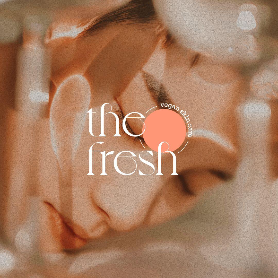 Close-up of a woman's face with soft focus and the text 'the fresh' and 'vegan skin care' in a circular design