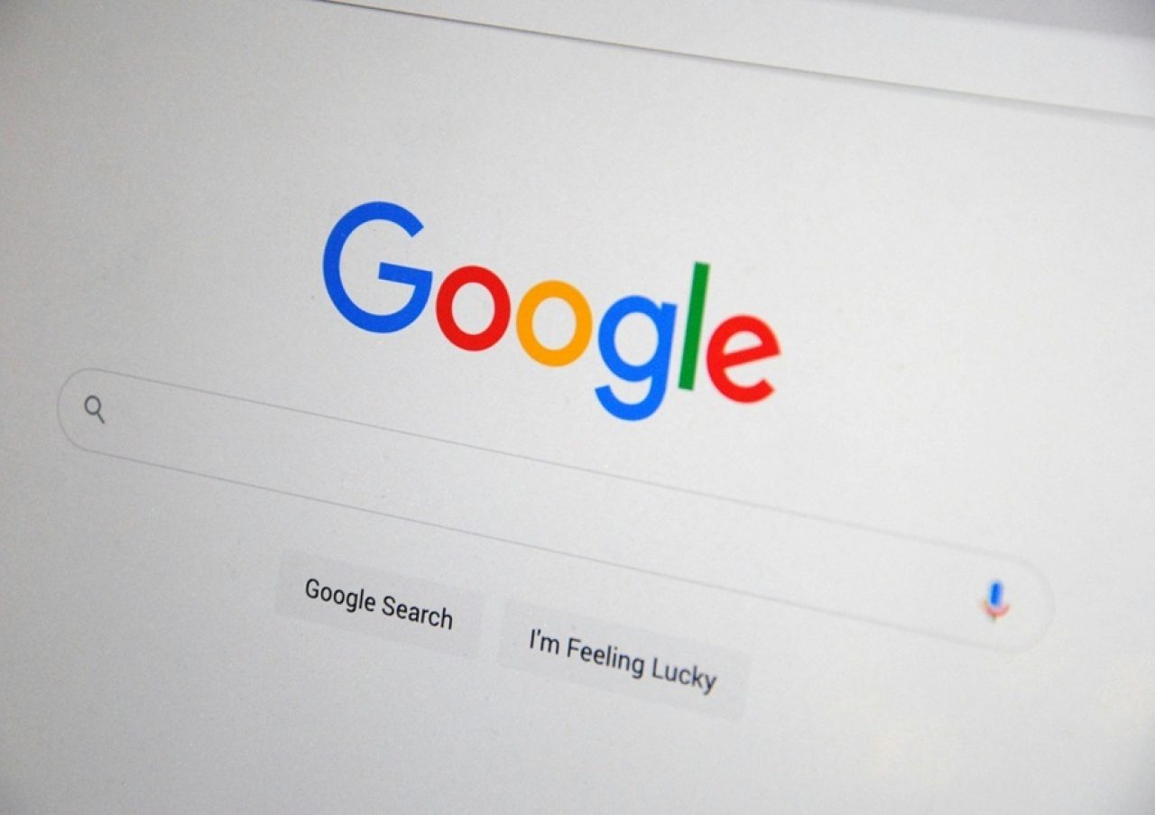 Close-up of the Google homepage on a desktop screen showing the search bar with Google Search and I'm Feeling Lucky buttons