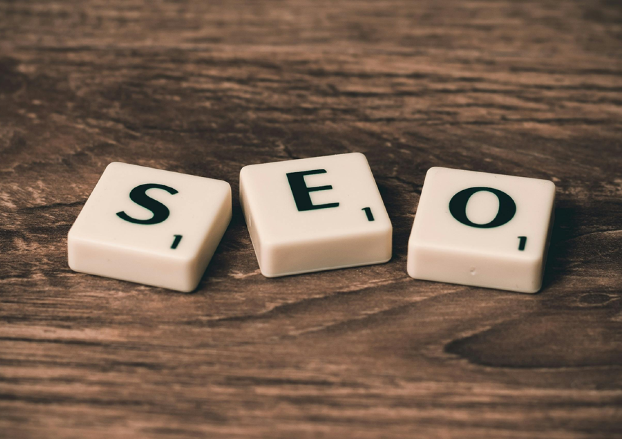 Scrabble tiles spelling out SEO placed on a wooden surface representing search engine optimisation