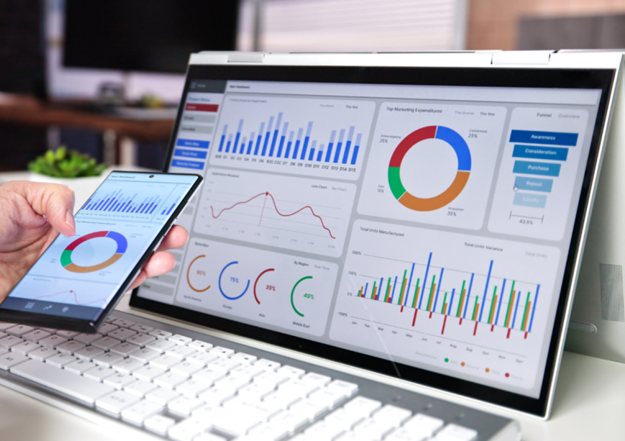 Dashboard showing marketing data with charts and graphs on a tablet and laptop screen