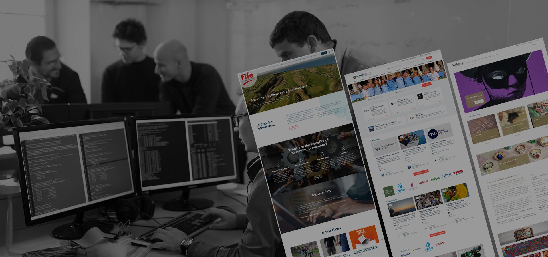 Software development team working collaboratively at desk with coding on screens and digital mockups of websites and applications floating above.