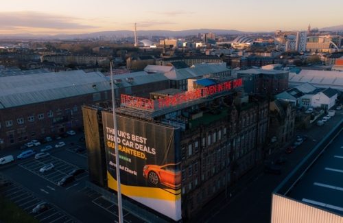 Aerial view of the Inspire office building in Glasgow with cityscape background at sunset