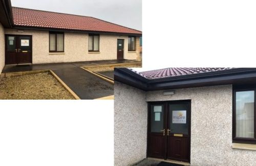 Entrance of Inspire Stirling office building with brown door featuring company logo sign