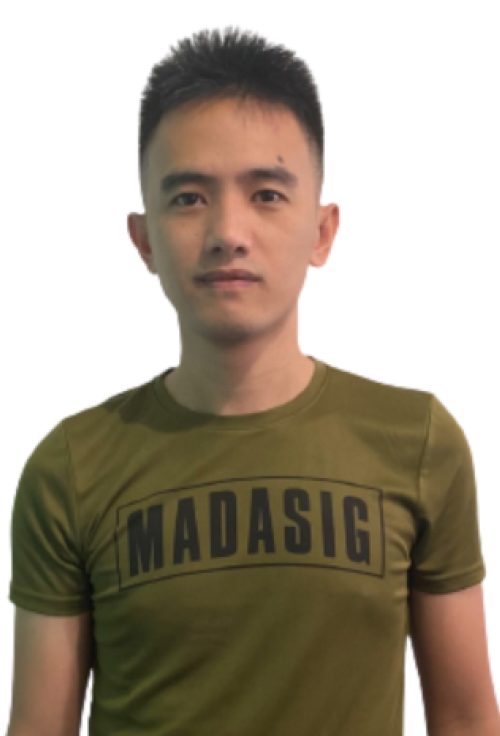 Portrait of a man wearing a green Madasig t-shirt against a plain background