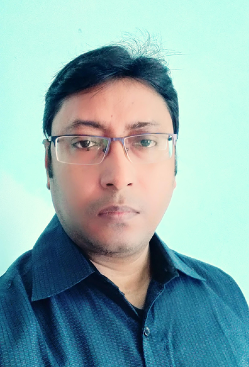 Headshot of Nilanjan Mahaparta wearing glasses and a dark blue shirt against a light background