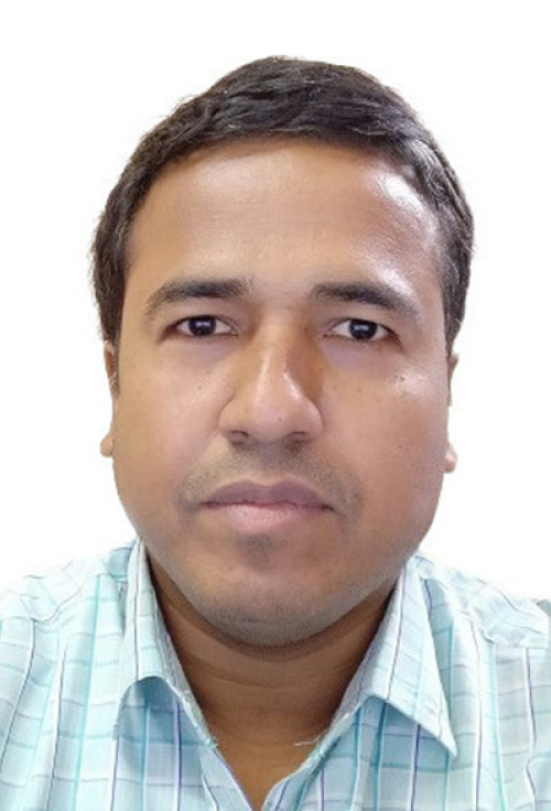 Headshot of a man with short dark hair wearing a checked shirt against a plain background