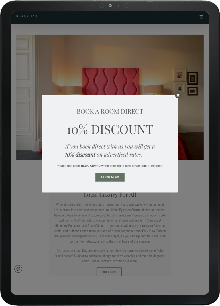 Tablet screen showing Black Ivy website with a pop-up offer for 10% discount on direct room bookings