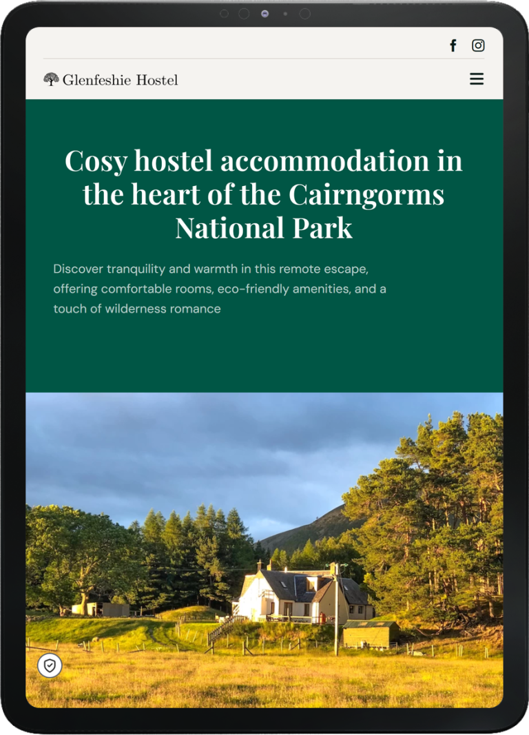 Tablet displaying Glenfeshie Hostel website homepage with a photo of a rural hostel surrounded by trees and hills under a moody sky