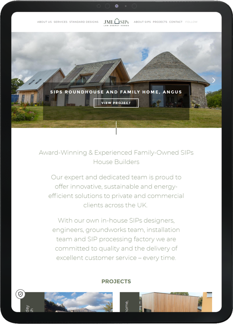 Tablet showing JML SIPS website homepage featuring a modern roundhouse and family home project with headline and navigation menu