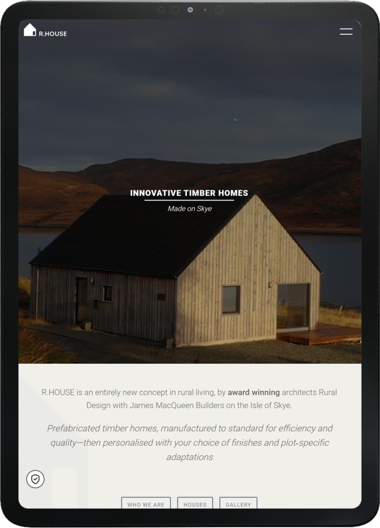 Tablet screen showing R.HOUSE website with image of a timber home and text about innovative prefab homes made on Skye